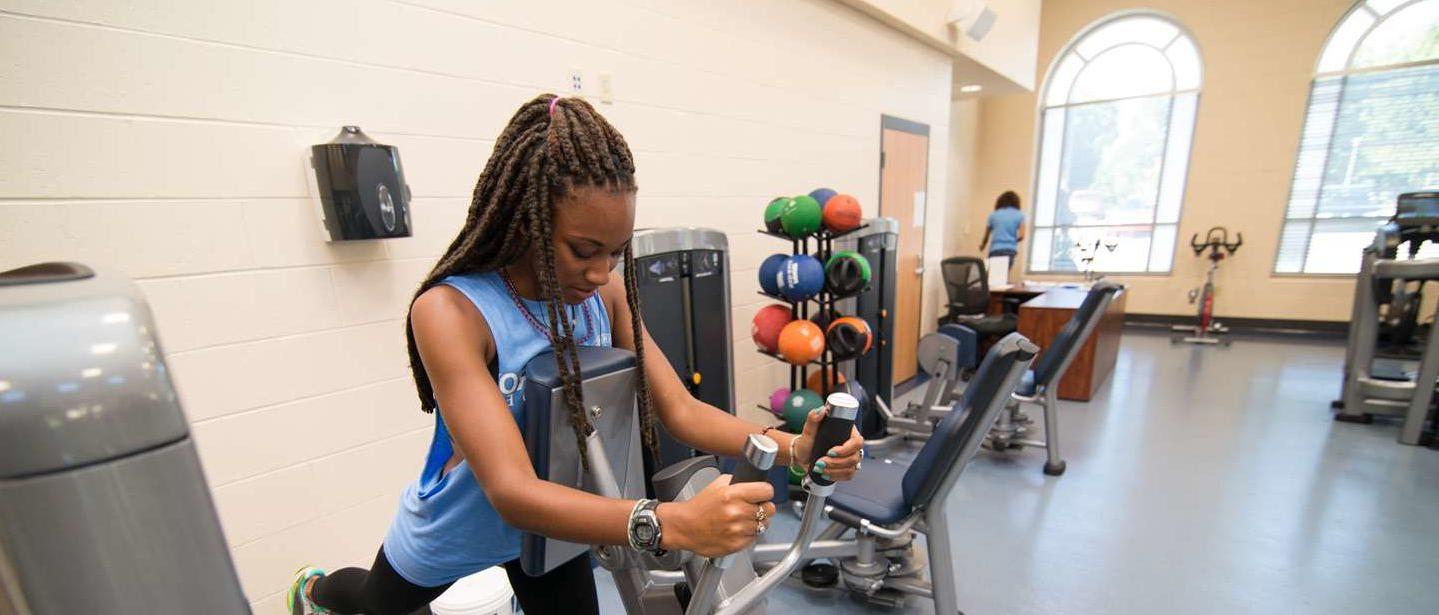 A young woman works out in the fitness center.